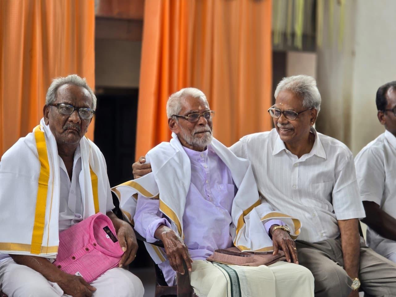 Rtn RC Nair at a community gathering with elders